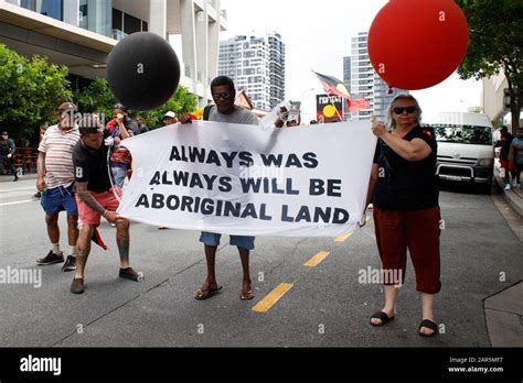 Protesters proudly hold a banner during the rally.Indigenous Yuggera ...