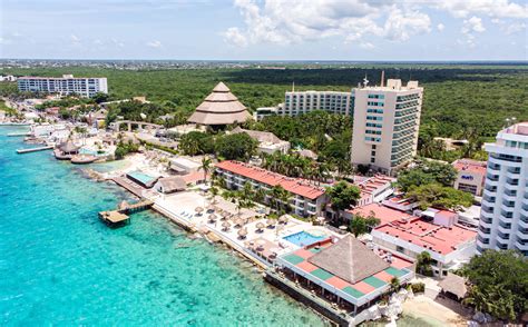 Aerial view of beach with turquoise waters with resort buildings in ...