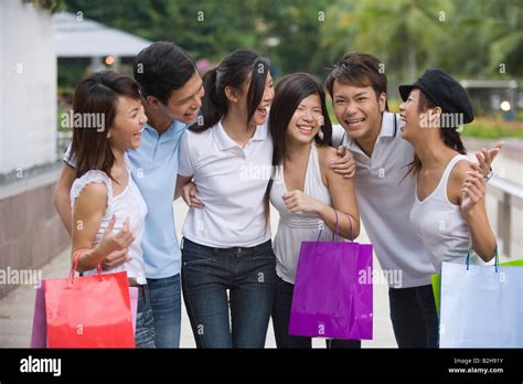 Group of friends standing together and smiling Stock Photo - Alamy