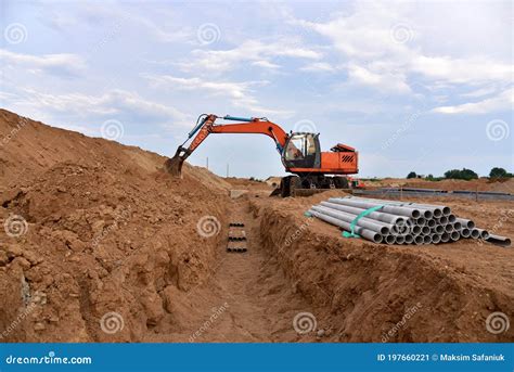 Excavator Dig The Trenches At A Construction Site. Trench For Laying ...