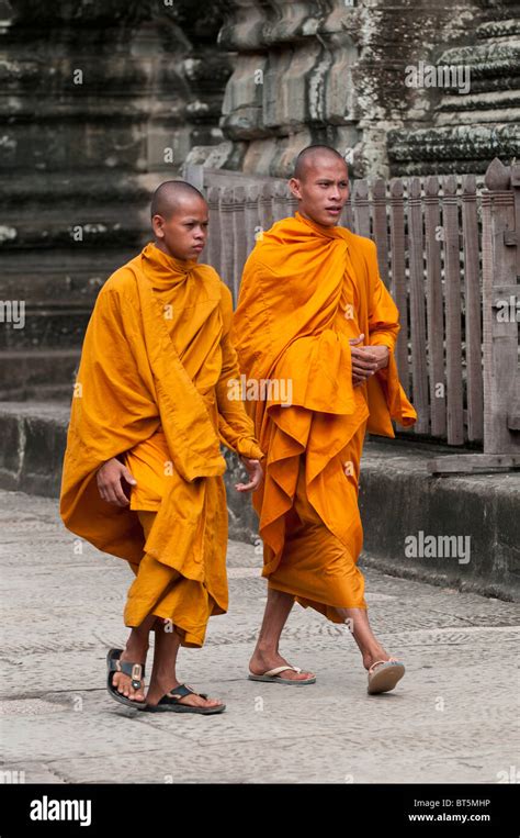 Two Young Buddhist Monks in Orange Robes in the Angkor Wat Temple Complex, Cambodia Stock Photo ...