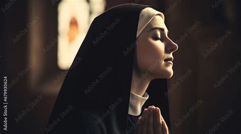 Faithful young Catholic nun praying in catholic church. Close-up photo ...