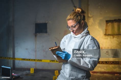 Beautiful Caucasian Female Taking Notes And Wearing A Forensics Uniform Stock Photo - Download ...