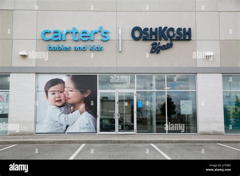 A logo sign outside of a Carter's, Inc., and OshKosh B'Gosh retail ...