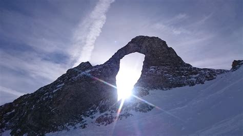 Sunshine trough "the eye of the needle"(L'Aiguille Percée). Tignes ...