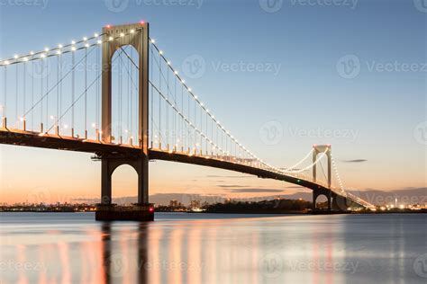 The Bronx-Whitestone Bridge reflecting on the East River at night in ...