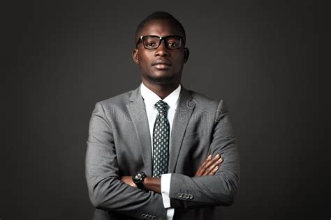 Serious Young Black Man with Glasses and Gray Business Suit Crossed His ...