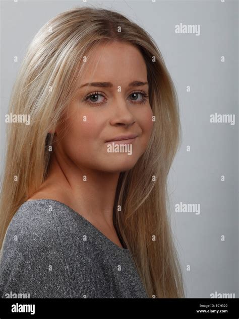 headshot or portrait of a young blonde woman with green eyes, wearing a gray top Stock Photo - Alamy