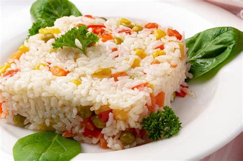 Premium Photo | Cooked white rice mixed with colorful vegetables on ...