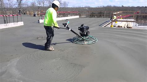 Finishing a concrete floor using a 4 foot walk-behind power trowel ...