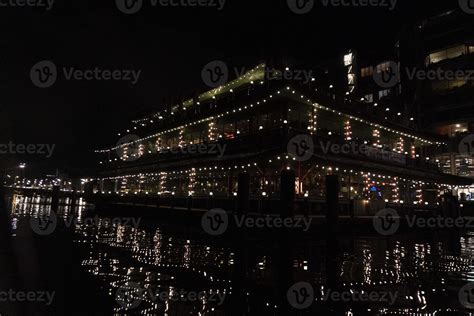 amsterdam canal at night view floating restaurant 20233698 Stock Photo at Vecteezy