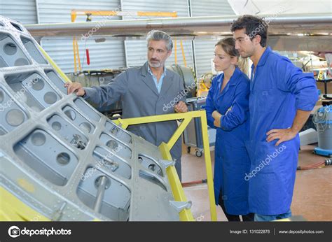 Apprentices with professional metallurgist Stock Photo by ...