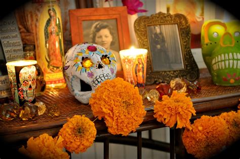 an altar honoring the deceased with sugar skulls, marigolds, and candles (día de los muertos ...