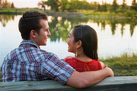 Mixed race couple spending quality time together in a park in autumn ...