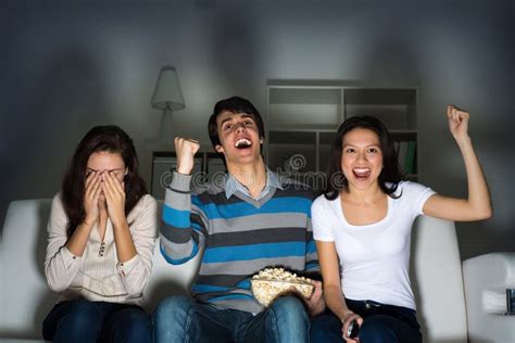 Group Of Young People Watching TV On The Couch Royalty Free Stock Image ...