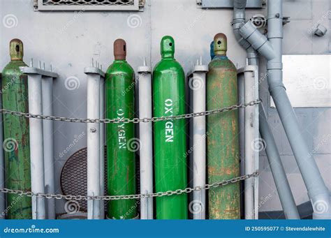 Compressed Gas Cylinders Being Stored Vertically Secured by a Metal ...