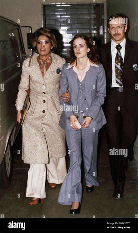 Patty Hearst, center, daughter of California newspaper magnate Randolph Hearst, is escorted by U ...