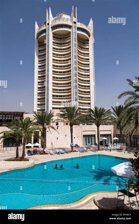The swimming pool of the Intercontinental Hotel with an office tower in Amman, Hashemite Kingdom ...