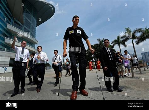 The world's tallest man, Sultan Kosen of Turkey, measuring 2 meters 51 cm (8-feet-3 inches) tall ...