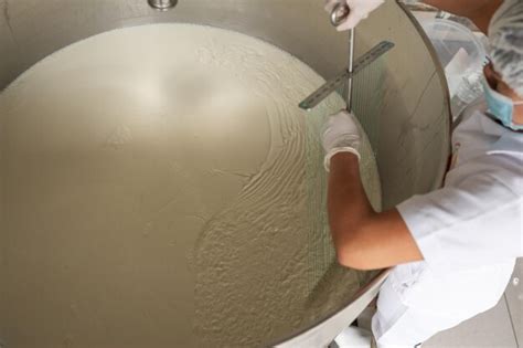 Premium Photo | Worker removing milk from a tank at a dairy factory