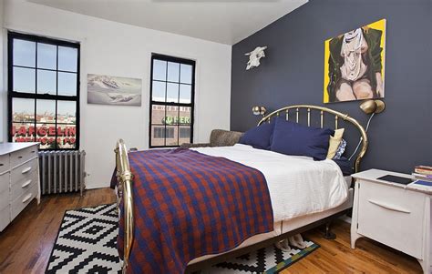 A navy-blue accent wall is the focal point of this bedroom. | Inside This Girls Star's Brooklyn ...