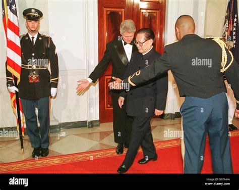 Chinese President Jiang Zemin is ushered by President Bill Clinton to a ...