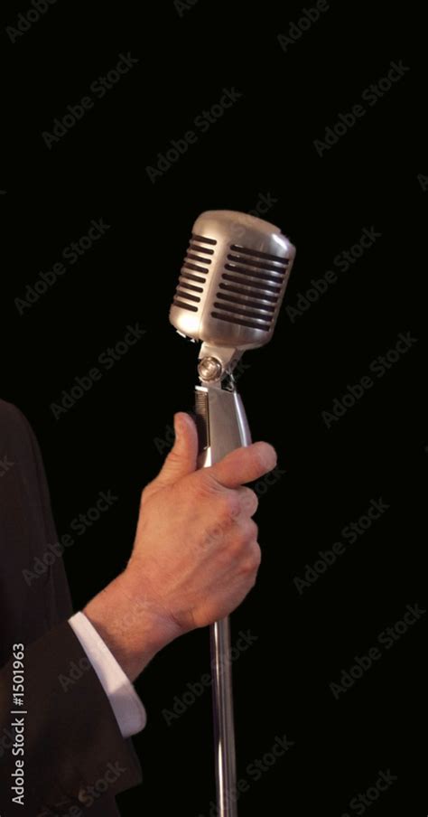 singer holding vintage microphone & stand Stock Photo | Adobe Stock