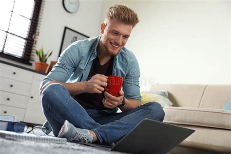 Young Man Using Laptop while Sitting on Floor in Room Stock Image ...