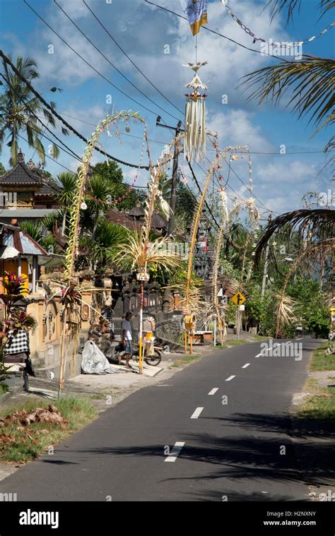 Indonesia, Bali, Putung, Kuningan festival, penjor decorations arching across road Stock Photo ...