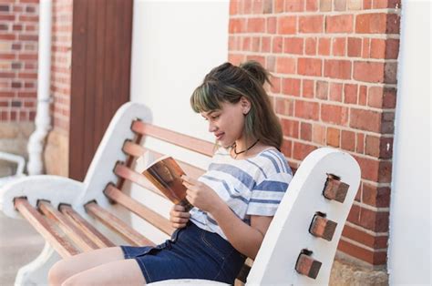 Free Photo | Reading girl sitting on a bench