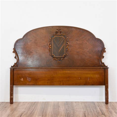 This antique full sized headboard is featured in a solid wood with a glossy walnut finish and ...