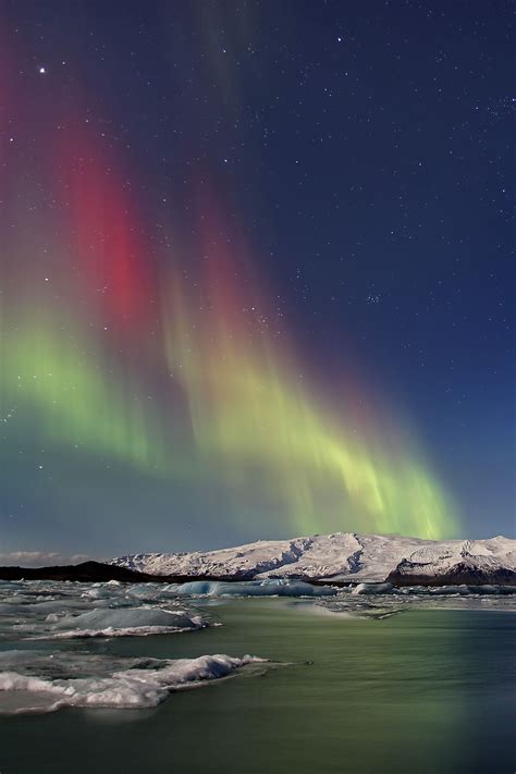 The Northern Lights dance across the sky at the Jökulsárlón Glacial Lagoon in Iceland. Northern ...