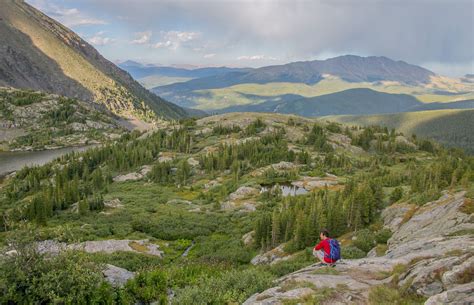 A man hiking the Mohawk Lakes Trail in Breckenridge in Summer, one of the moderate hiking trails ...