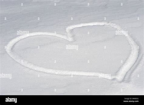 Heart shape in snow Stock Photo - Alamy