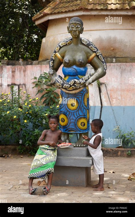 Children and statue outside Python Temple, Ouidah, Benin Stock Photo ...