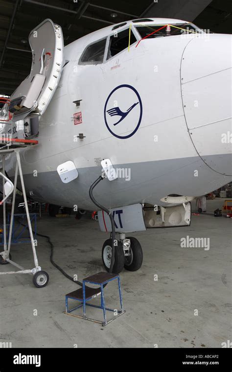 Boeing 737 jet airline airliner undergoing overhaul maintenance inspection in hangar Stock Photo ...