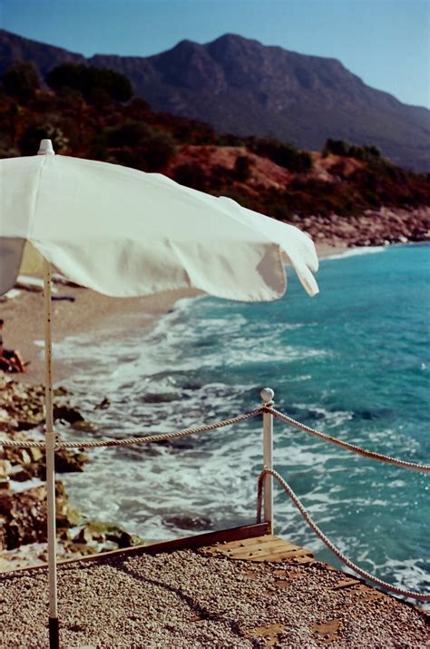 A White Parasol on the Beach · Free Stock Photo