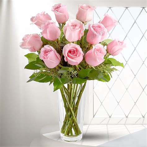 12 Light Pink Roses with fillers in a Glass Vase