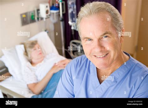 Doctor Standing And Smiling In Patients Room Stock Photo - Alamy