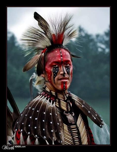 a native american man with red and black paint on his face, wearing an elaborate headdress