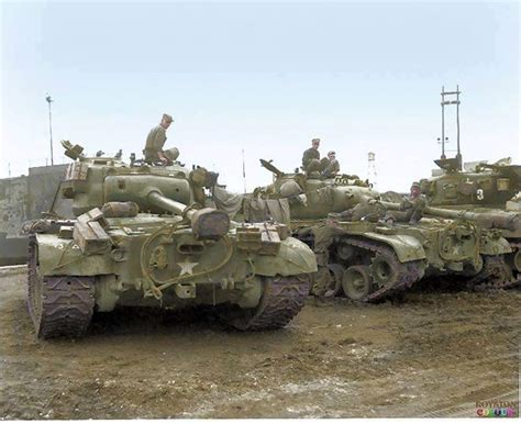 M26 Pershing tanks from the 73rd heavy tank Battalion being loaded up onto ships to participate ...