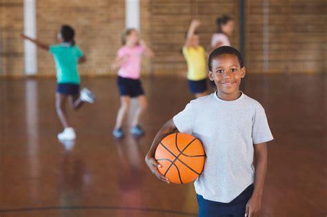 Boy standing with ball in basketball court - The Alliance of Southwest Missouri