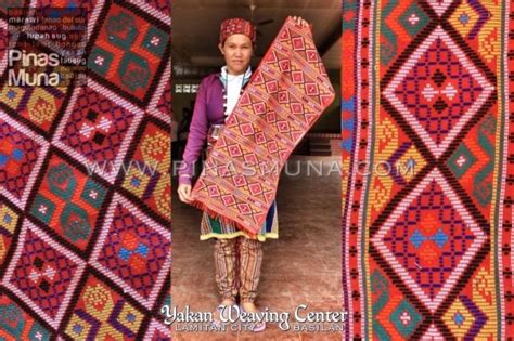 a woman is standing in front of some colorful rugs and holding a large ...