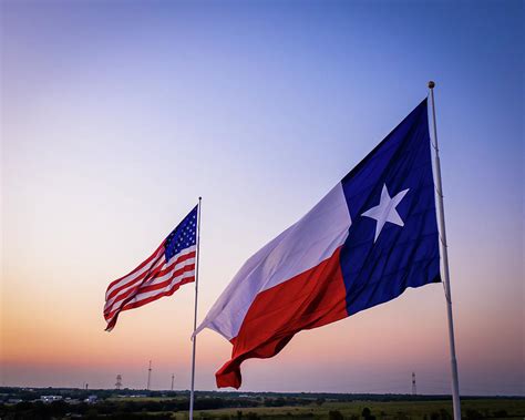 Texas and American flags waving above the Texas Countrside Photograph ...