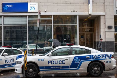 Two Montreal Police Service SPVM Cars Standing in Front of a Local Police Station. the SPVM is ...