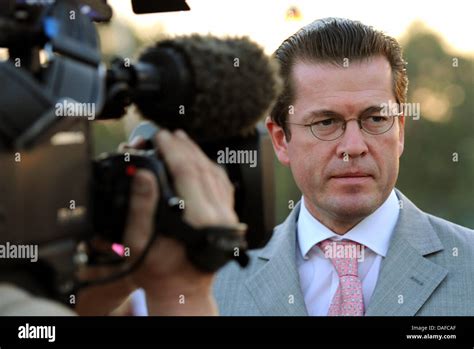 German Minister of Defence Karl-Theodor zu Guttenberg stands in front ...