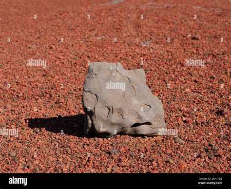 Stone on red ferruginous volcanic rock Stock Photo - Alamy