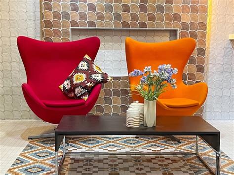 Premium Photo | Closeup red and orange modern chair with flower vase on ...