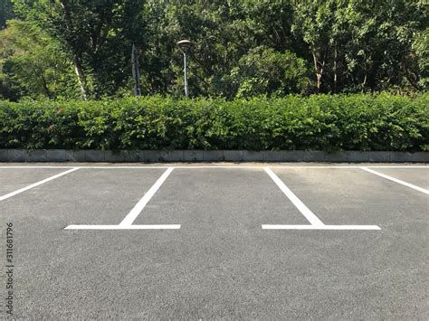 Empty outdoor parking space. Car parking lot with white lines mark. Stock Photo | Adobe Stock