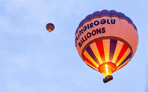 Goreme, Turke, 2019- Tourists riding the colorful hot air balloon which it is flying over Goreme ...